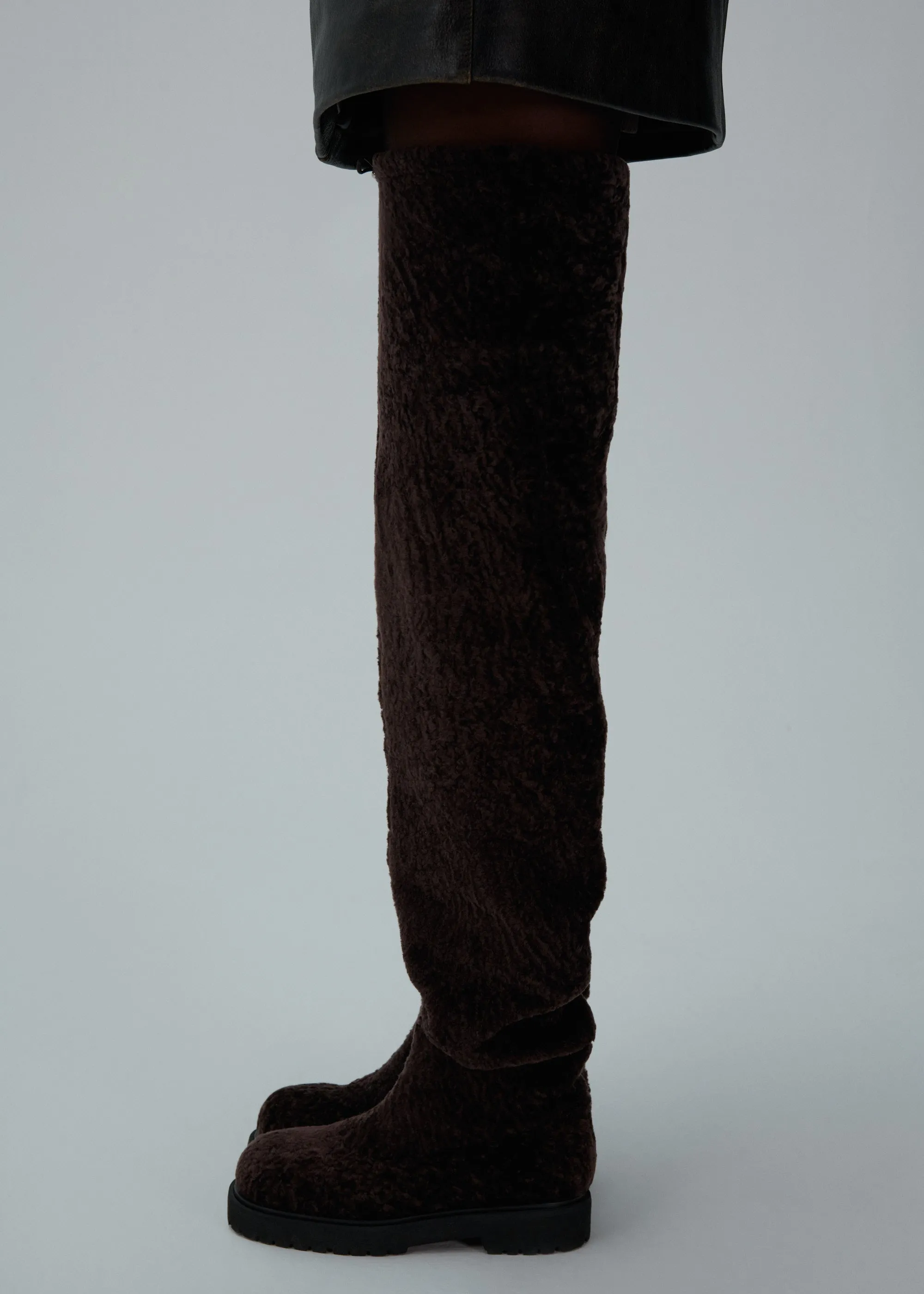 Thigh-high fur boots in brown